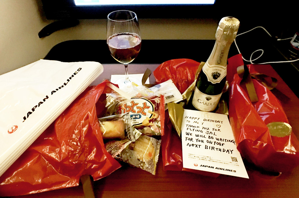 JAL F flight attendants gave me 2 bottles of champagne and a large bag of delicious Japanese snacks, accompanied by a handwritten card. I received a different gift on my return flight too!
